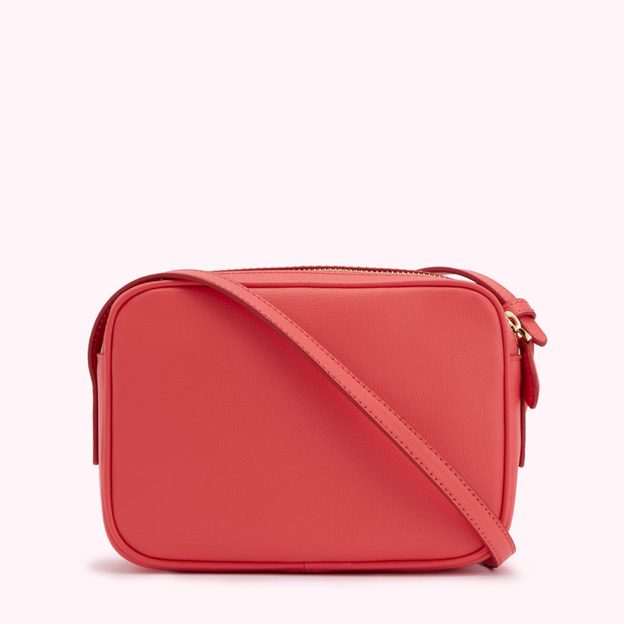 Coral-coloured leather crossbody bag with a gold zipper.
