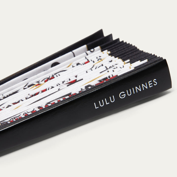 Lulu Guinness handheld fan with patterned design on a white background