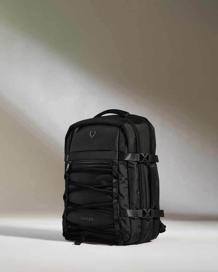 a black backpack with a light shining on it
