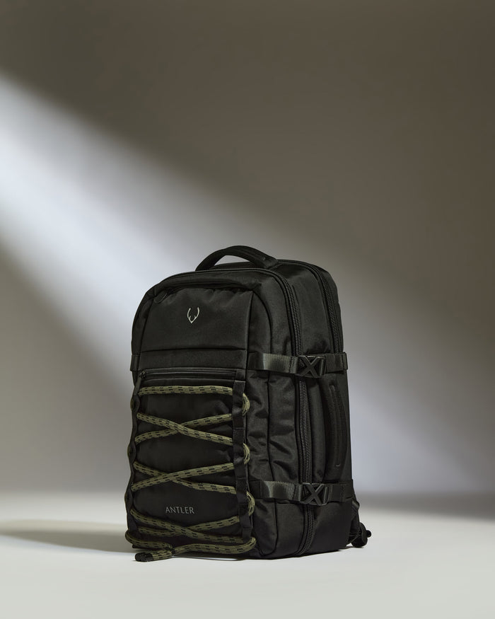 a black backpack with a light shining on it