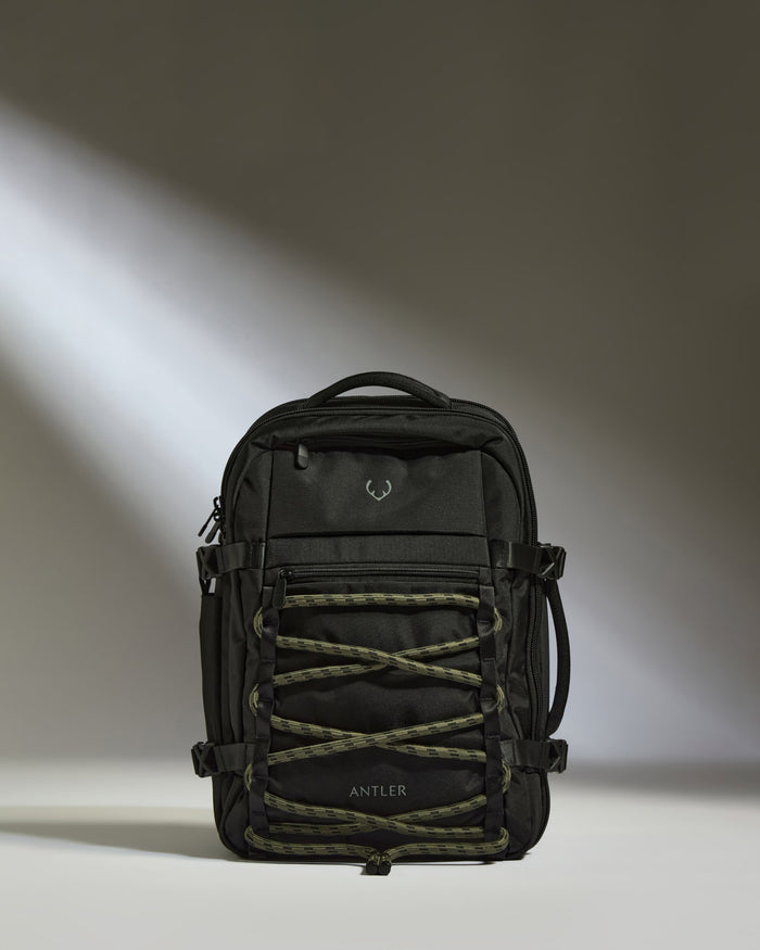 a black backpack with a light shining on it