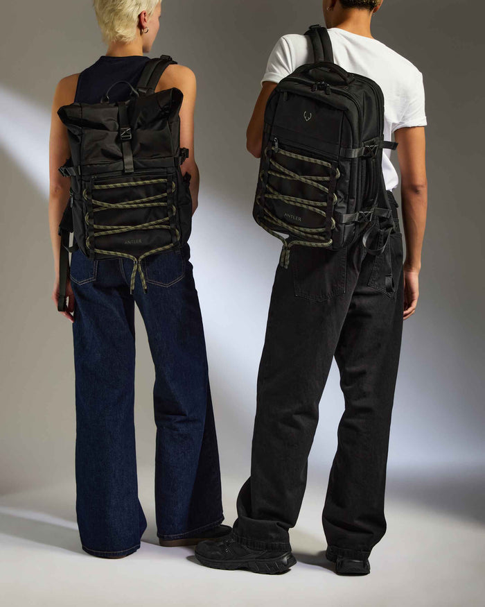 two men wearing backpacks