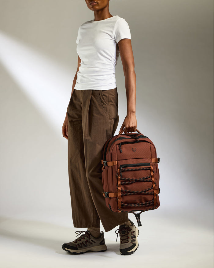a woman holding a backpack