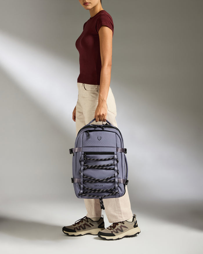 a woman holding a backpack