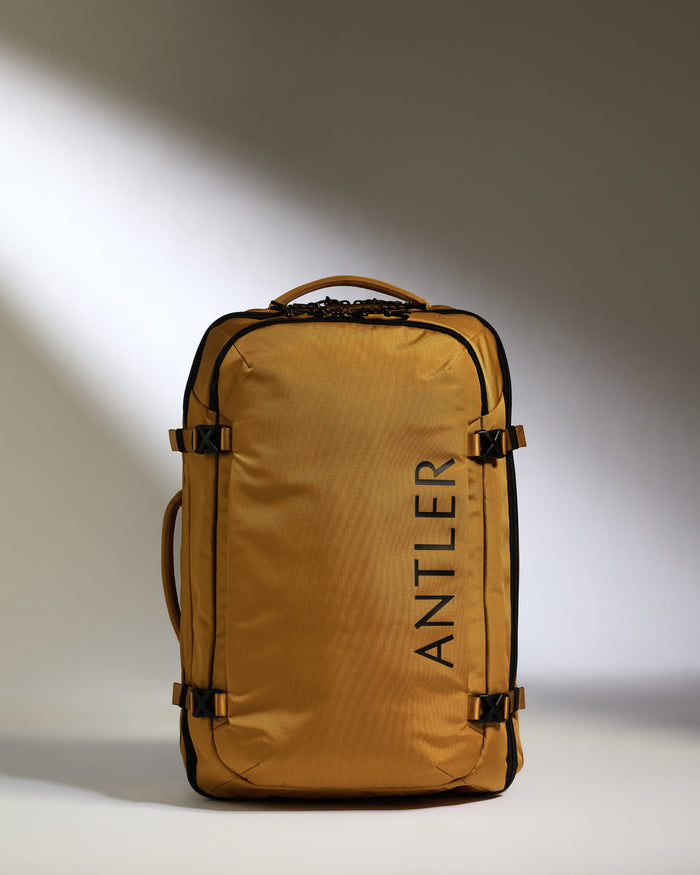 a gold suitcase with black text