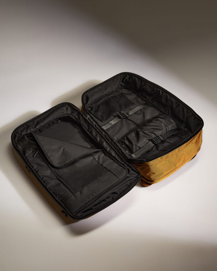 a black and gold bag with a black zipper