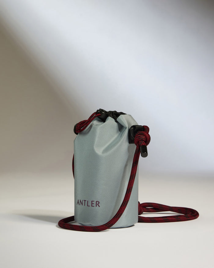 a silver bag with red rope