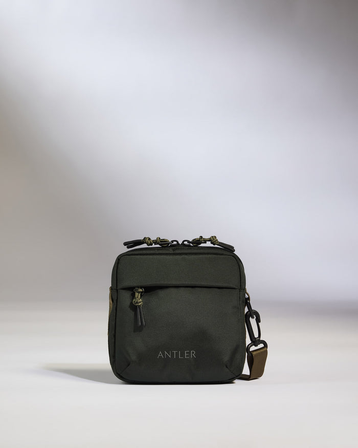a small black bag with a brown strap