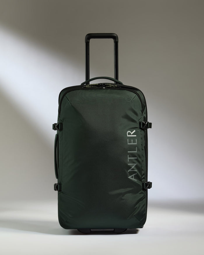 a green suitcase with handle