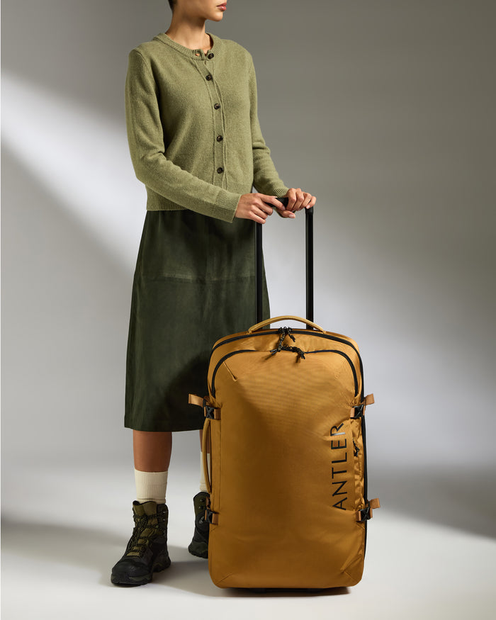 a woman standing with a suitcase