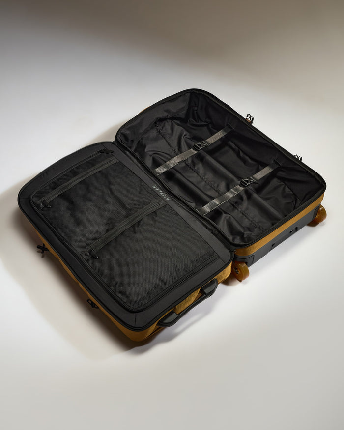 a black and tan suitcase with wheels