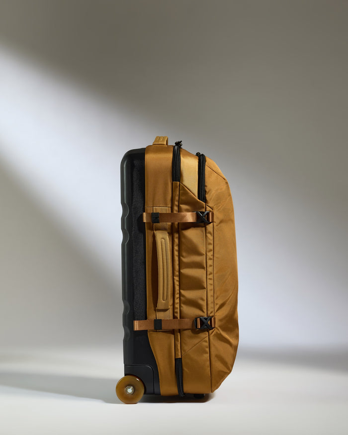 a black and gold suitcase with wheels