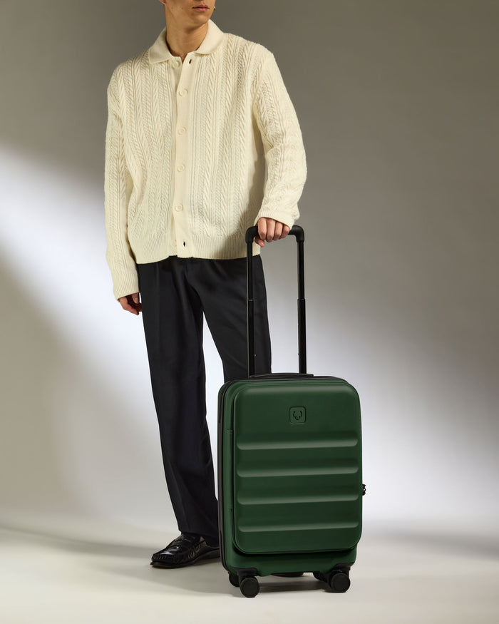 a man with a green suitcase