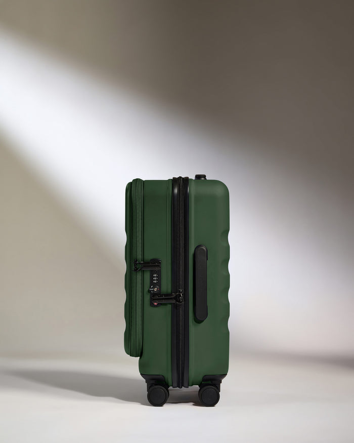 a green suitcase with wheels