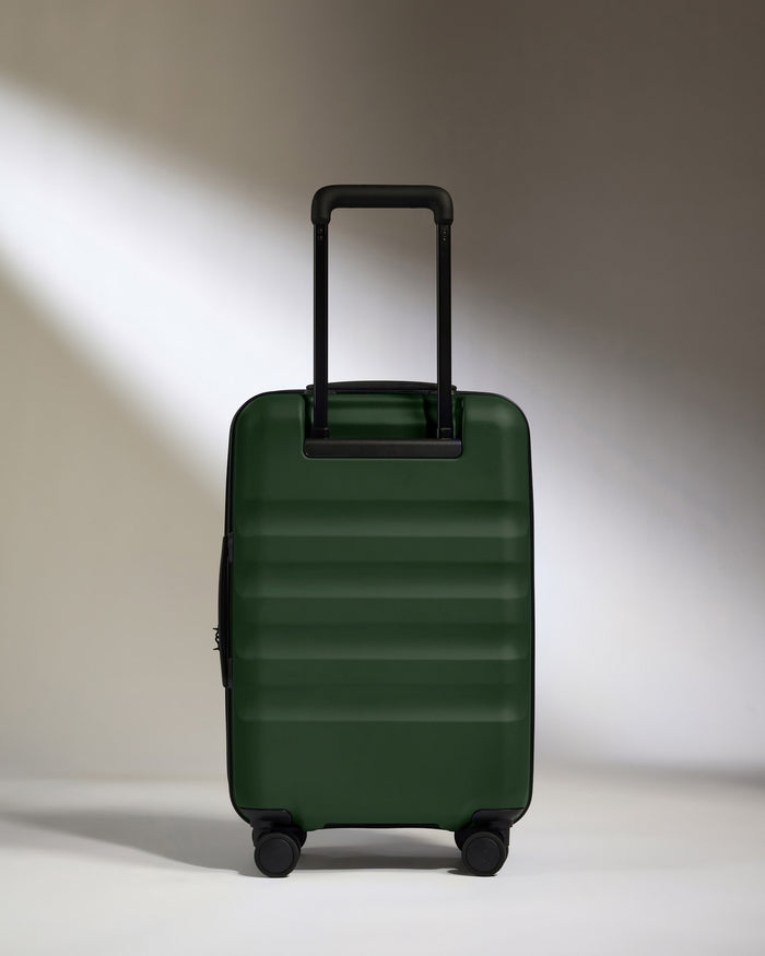 a green suitcase with black wheels