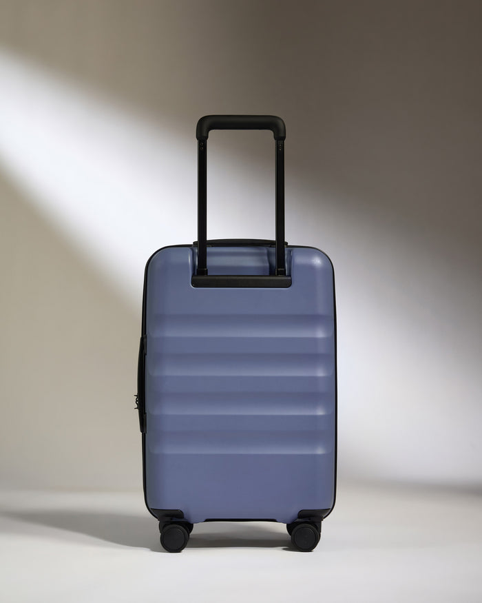 a blue suitcase with black handles