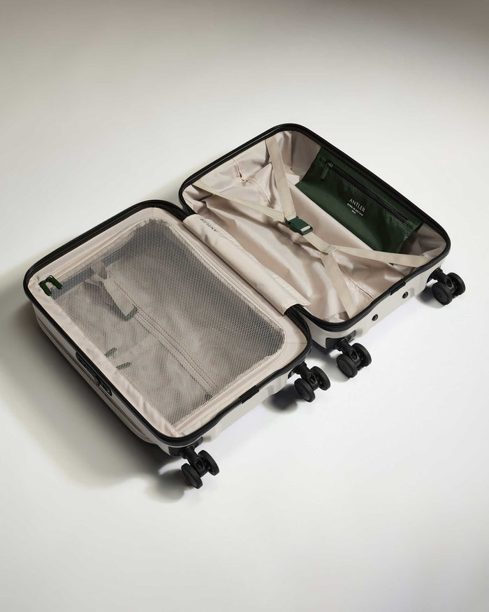 a suitcase with wheels and a white cover