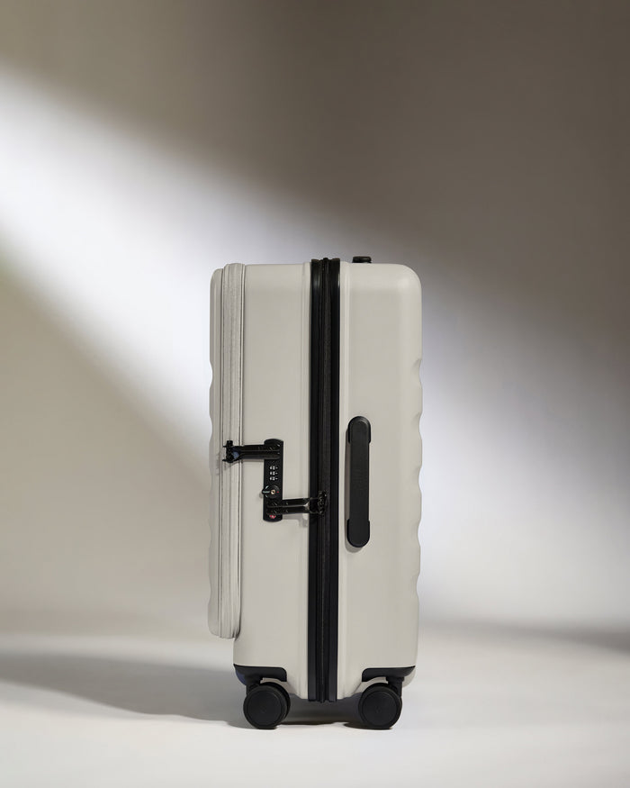 a white suitcase with black wheels