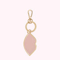 Pink lip-shaped keychain with gold accents and Lulu Guinness branding.