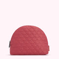 Half-moon shaped quilted cosmetic bag in dusty rose with a lip print.