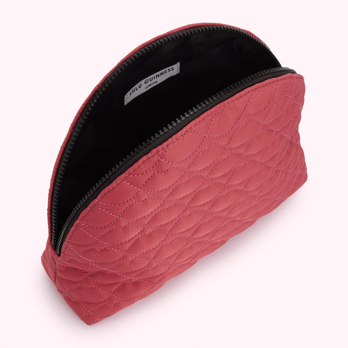 Red quilted makeup bag by Lulu Guinness, London.