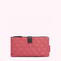 Dusty rose quilted zip-around pouch with black zipper and accent.