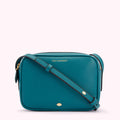 Teal Lulu Guinness crossbody bag with gold lettering and a gold lip detail.