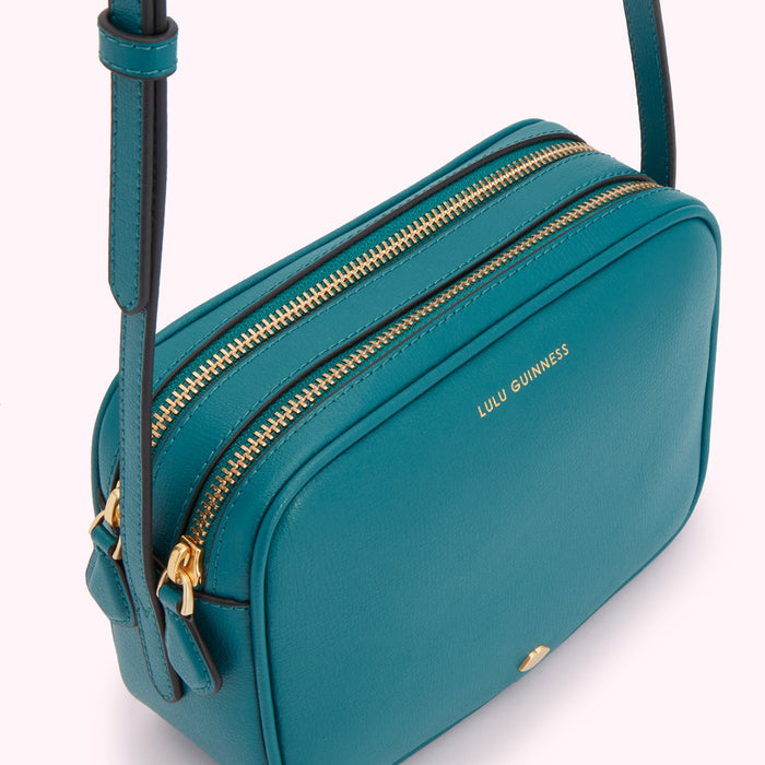 Teal Lulu Guinness crossbody bag with gold zippers.