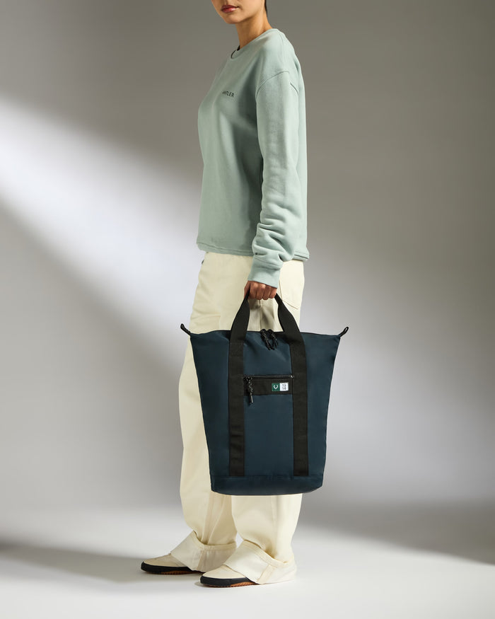 a woman holding a blue bag