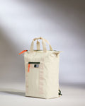 a white bag with a red and green strap