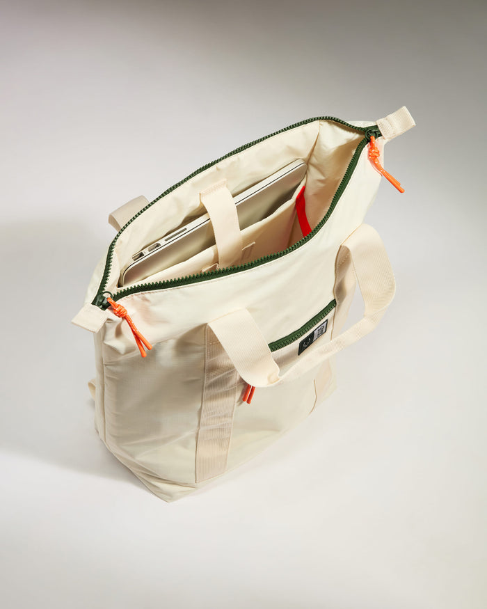 a white bag with a green strap
