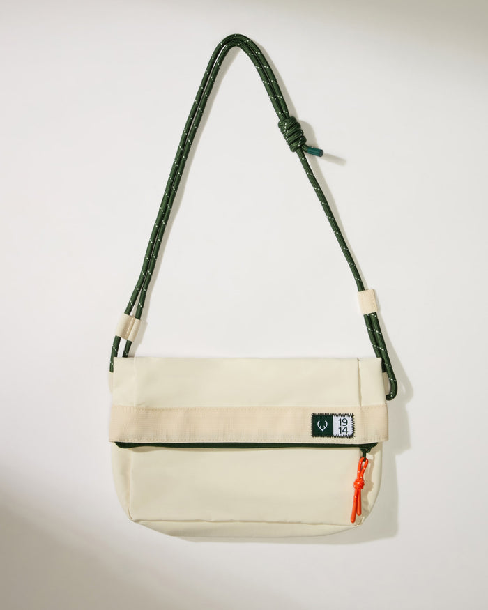 a white bag with a green strap