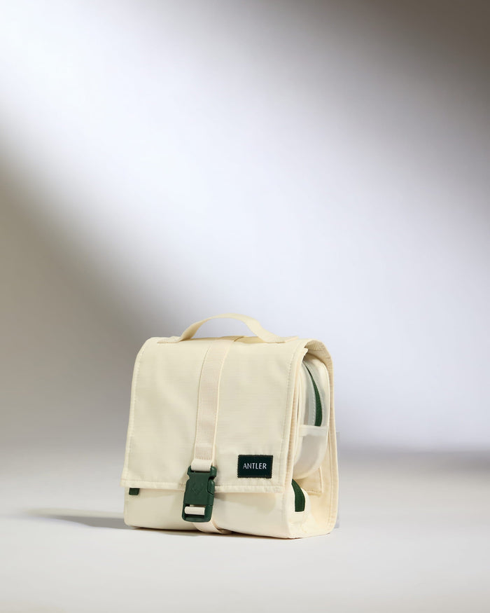 a white bag with a green buckle
