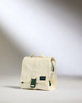 a white bag with a green buckle