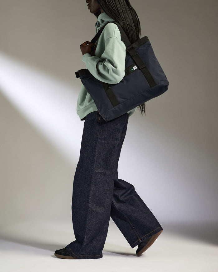 a woman walking with a bag