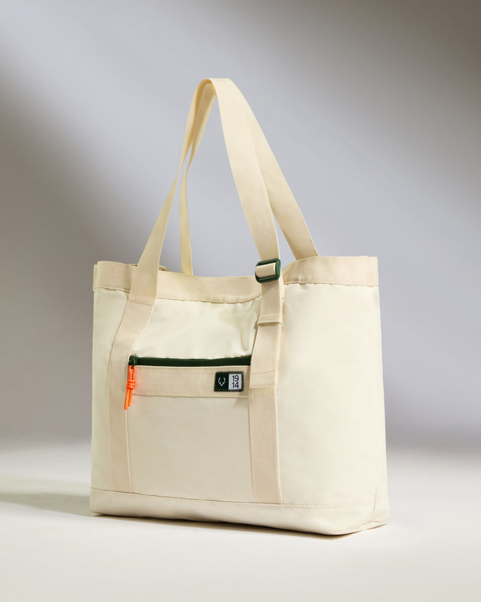 a white bag with a green strap