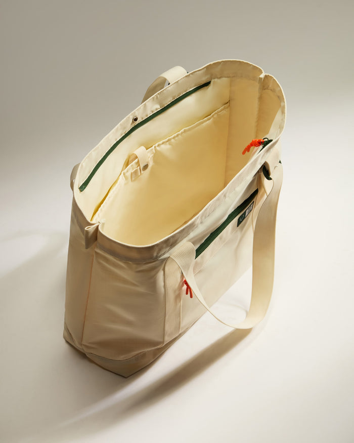 a white bag with a green strap