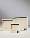 a group of white bags with orange ties