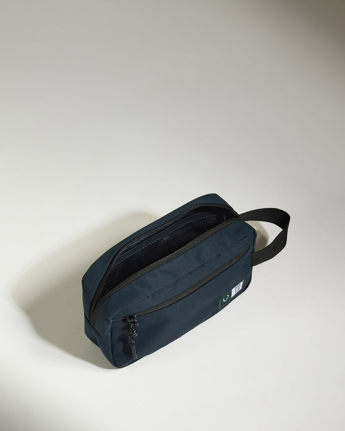 a small blue bag with a black strap