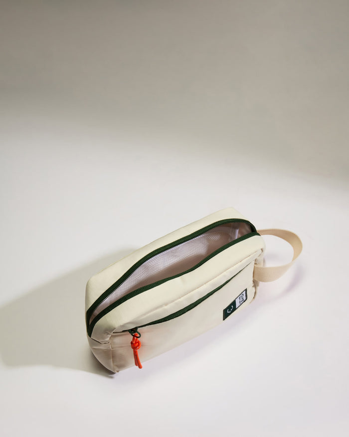 a small white bag with a red zipper