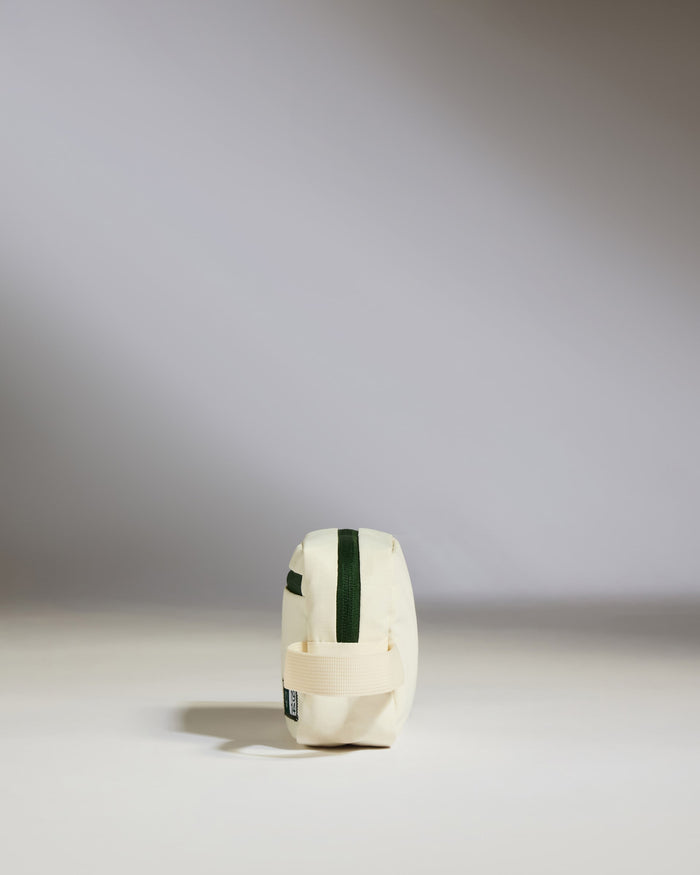 a small white bag with a green stripe