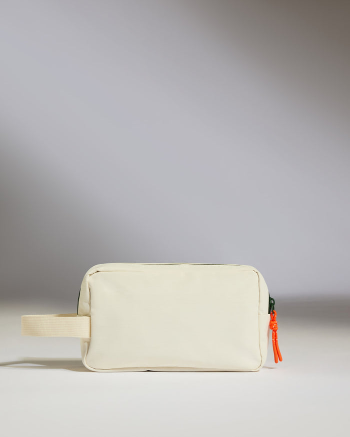 a white bag with a red zipper