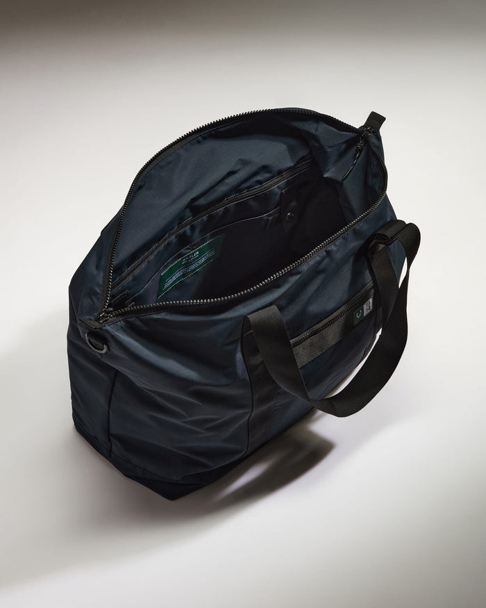 a black bag with a green label inside