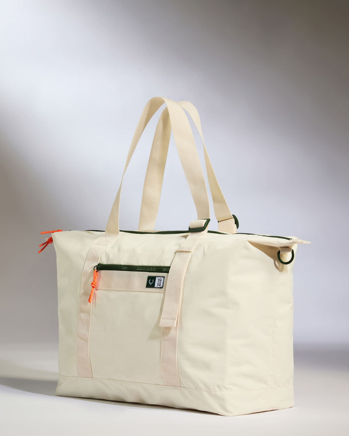 a white bag with a green strap