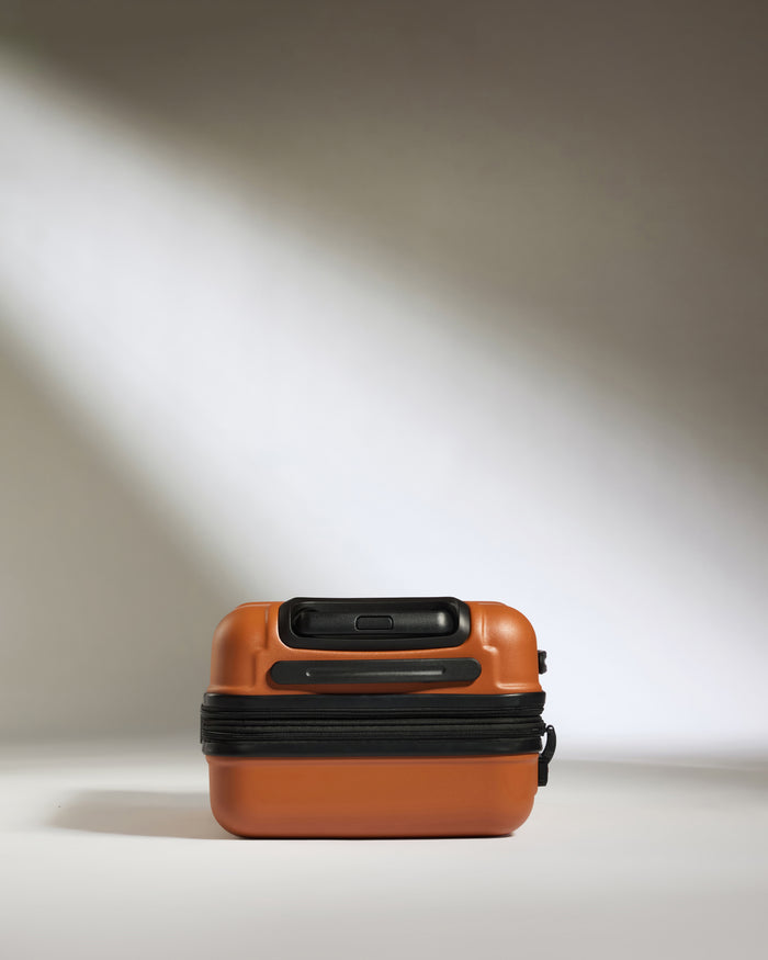 a brown suitcase with black straps