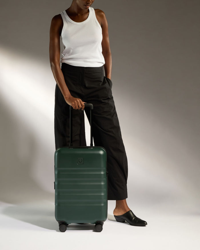 a woman standing with a suitcase