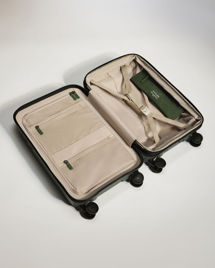 a suitcase with wheels and a green tag