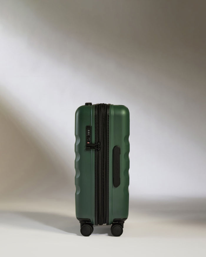 a green suitcase with wheels