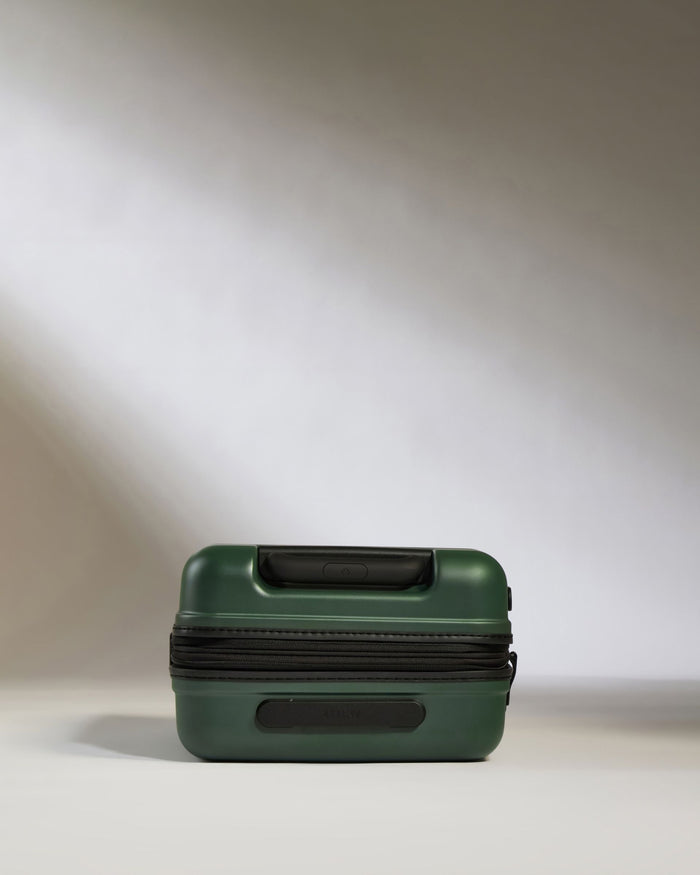 a green suitcase with a zipper