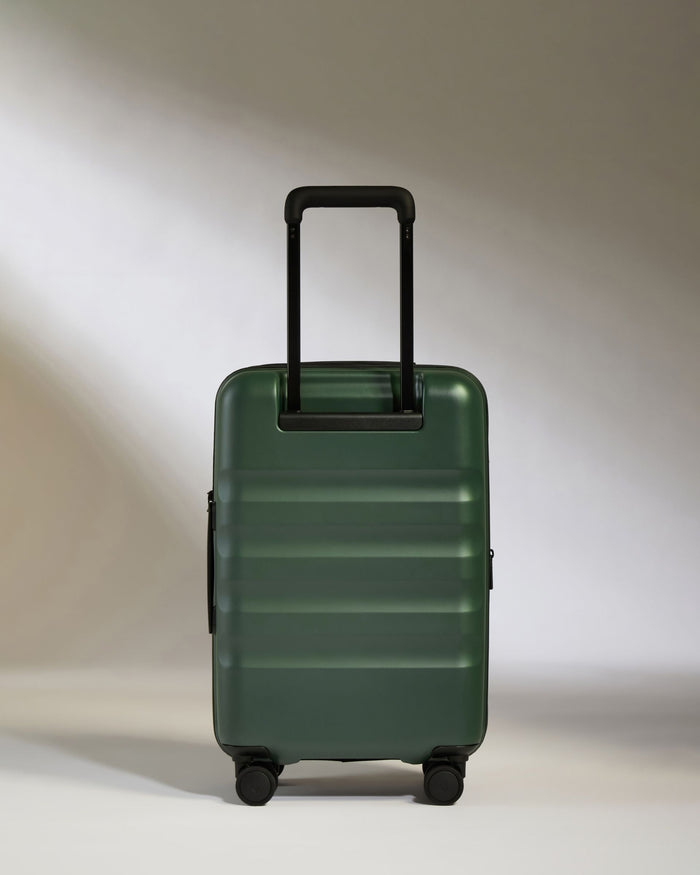 a green suitcase with black handles